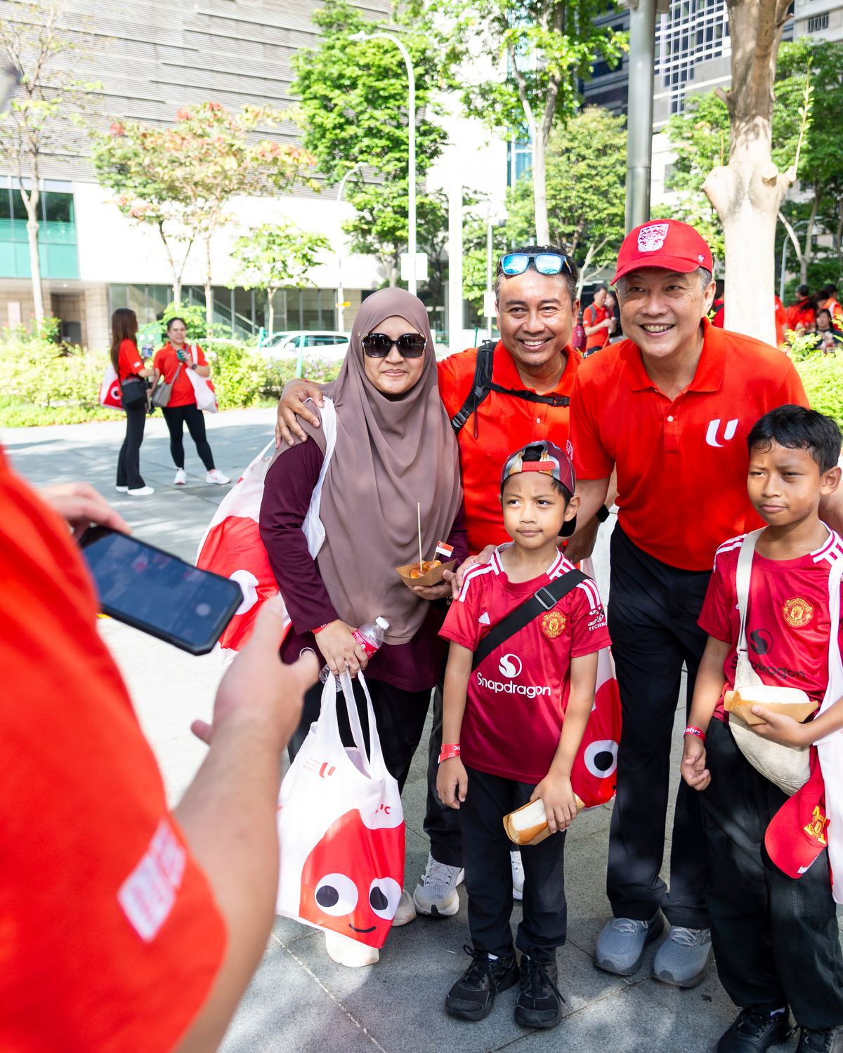Participants posing for a mobile photo checkpoint during an outdoor event